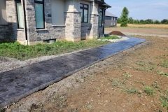 Stamped-concrete-walkway-to-backyard-scaled